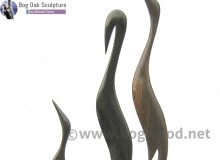 Family of herons in bog oak by Michael Casey