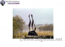 Family of herons in bog oak by Michael Casey