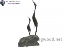 Family of Two Herons in bog oak by Michael Casey